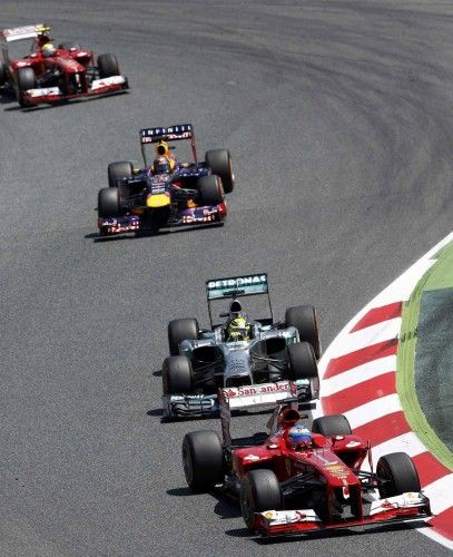 Ferrari Formula One driver Fernando Alonso of Spain leads the race ahead of Mercedes driver Rosberg and Red Bull driver Vettel of Germany during the Spanish F1 Grand Prix at the Circuit de Catalunya in Montmelo, near Barcelona