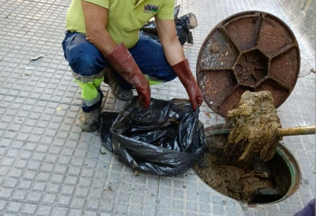 Un operario durante el desatoro de una tubería en la red de saneamiento de Málaga