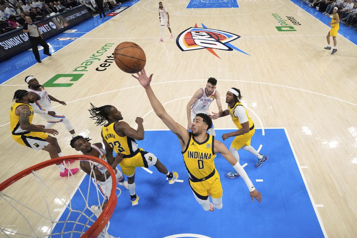 Indiana Pacers guard Tyrese Haliburton (0) reaches for the ball against the Oklahoma City Thunder during the first half in Game 1 of the NBA Finals basketball series Thursday, June 5, 2025, in Oklahoma City. (Kyle Terada/Pool Photo via AP)