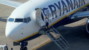 A cabin crew staff member enters a Ryanair plane at the airport, during a protest on the second and last day of a cabin crew strike held in several European countries, in Valencia, Spain July 26, 2018 REUTERS/Heino Kalis