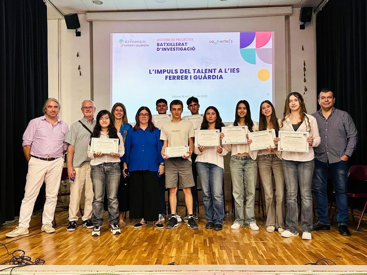 La promoció 2025-2026 del 'Batxillerat d'Investigació' de l'IES Francesc Ferrer i Guàrdia de València, junt amb els membres del tribunal avaluador.