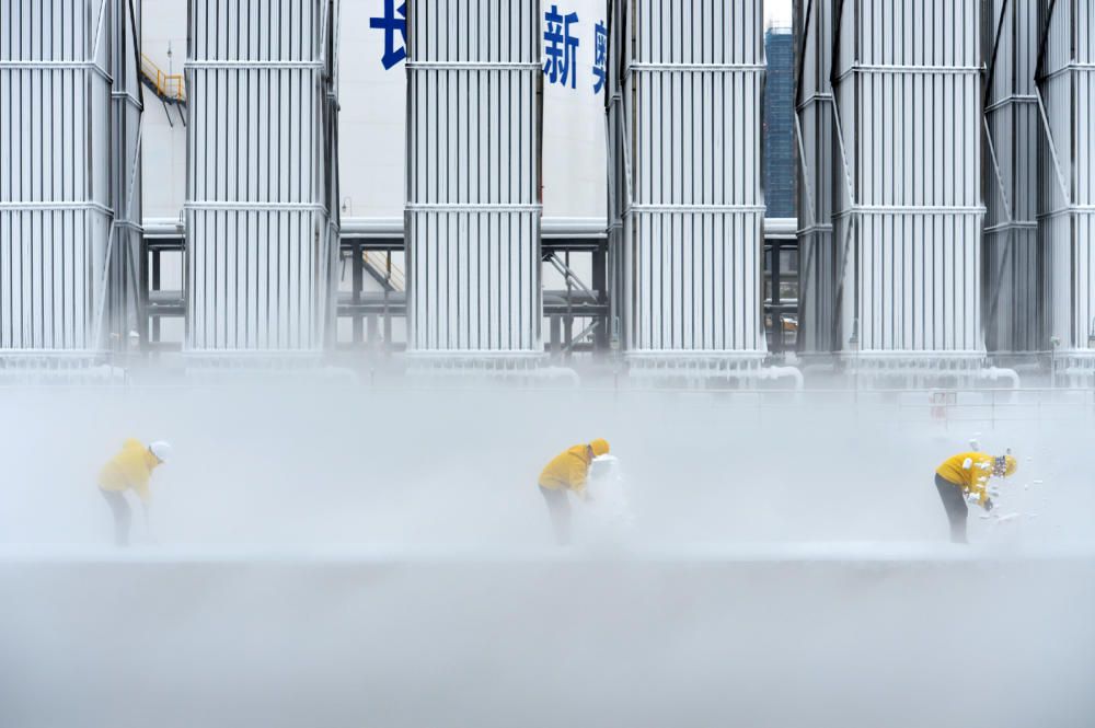 Workers remove snow at LNG facility of ENN Group ...