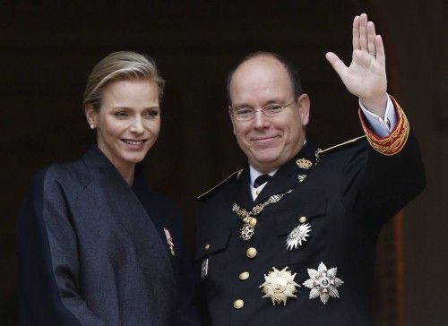 Prince Albert II of Monaco and his wife Princess Charlene wave from the Palace balcony during Monaco's National Day