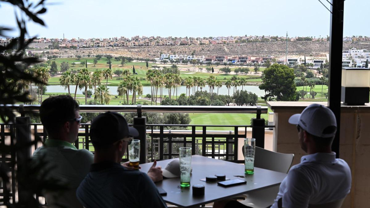 Una familia en la terraza de un complejo de golf en La Algorfa.