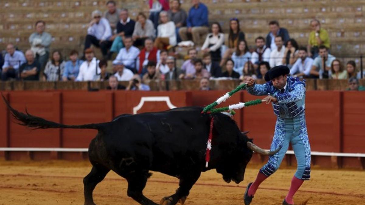 Spanish banderillero Antonio Osuna is tackled by a bull in the Andalusian capital of Seville, southern Spain