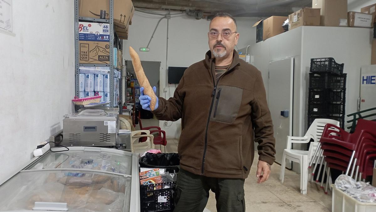 Curro López, presidente vecinal de Lagunillas, con una de las barras de pan donadas por la empresa valenciana.