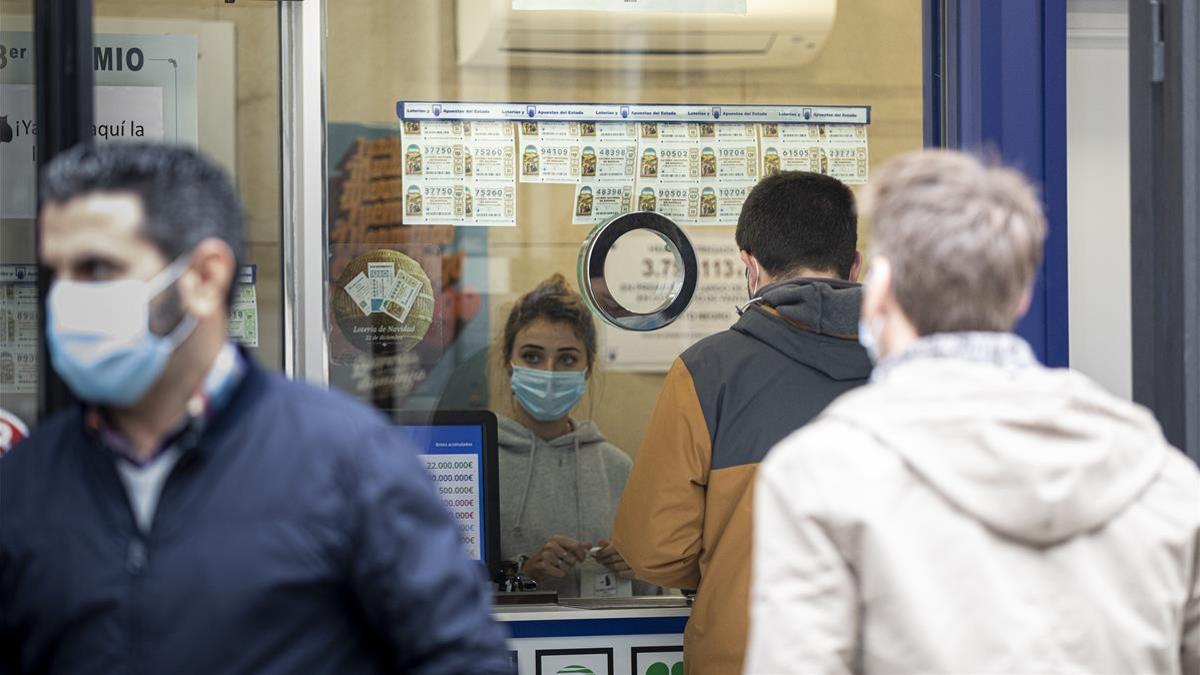 Colas para comprar la loteria de Navidad en una administración