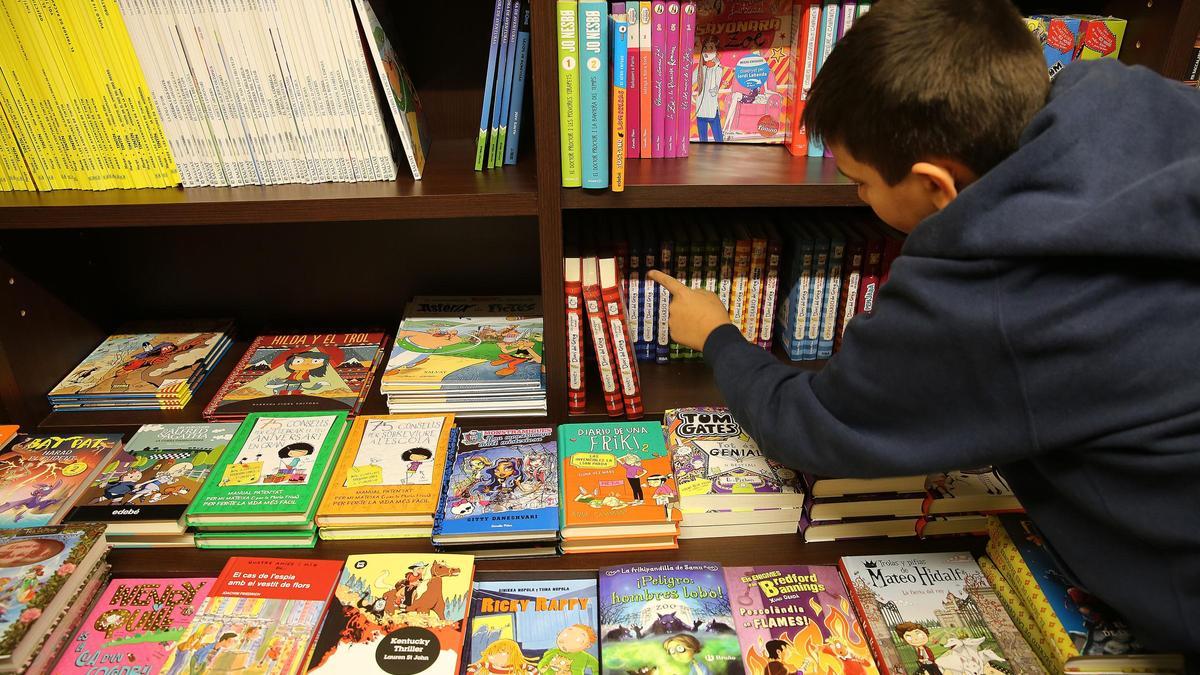Un niño, escogiendo un libro en una librería de Barcelona