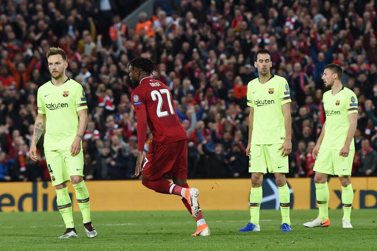 Liverpool's Belgium striker Divock Origi (2L) celebrates after scoring their fourth goal during the UEFA Champions league semi-final second leg football match between Liverpool and Barcelona at Anfield in Liverpool, north west England on May 7, 2019. (Photo by Paul ELLIS / AFP). HORIZONTAL