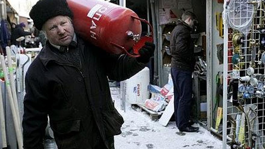 Un hombre transporta una bombona de gas en Donetsk, Ucrania.