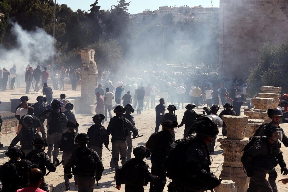 Smoke is seen after sound grenades exploded as Israeli police clash with Palestinian worshippers on the compound known to Muslims as Noble Sanctuary and to Jews as Temple Mount as Muslims mark Eid al-Adha in Jerusalem s Old City August 11  2019  REUTERS Ammar Awad