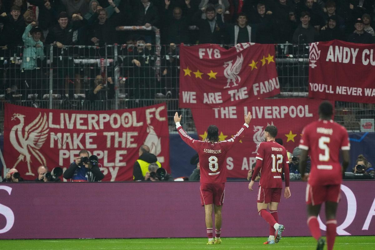 Liverpool's Dominik Szoboszlai, centre, celebrates after scoring his side's fifth goal during the Champions League opening phase soccer match between Eintracht Frankfurt and Liverpool in Frankfurt, Germany, Wednesday, Oct. 22, 2025. (AP Photo/Michael Probst)