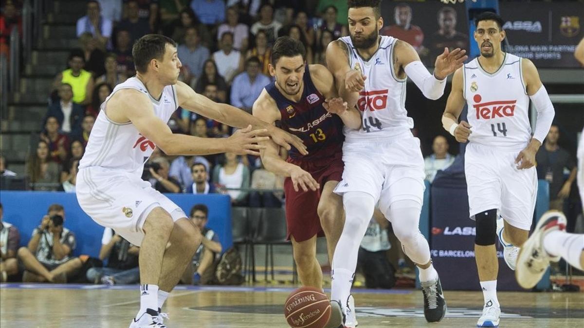 El base azulgrana Satoransky trata de avanzar entre Taylor y Maciulis