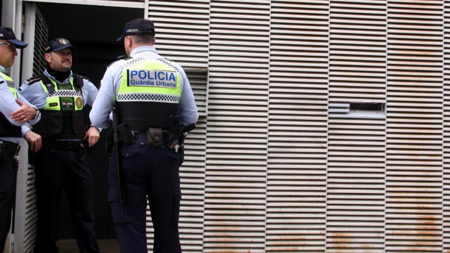 Agents de la Guàrdia Urbana de Figueres controlant l&#039;accés a un dels blocs ocupats de la plaça Joan Tutau