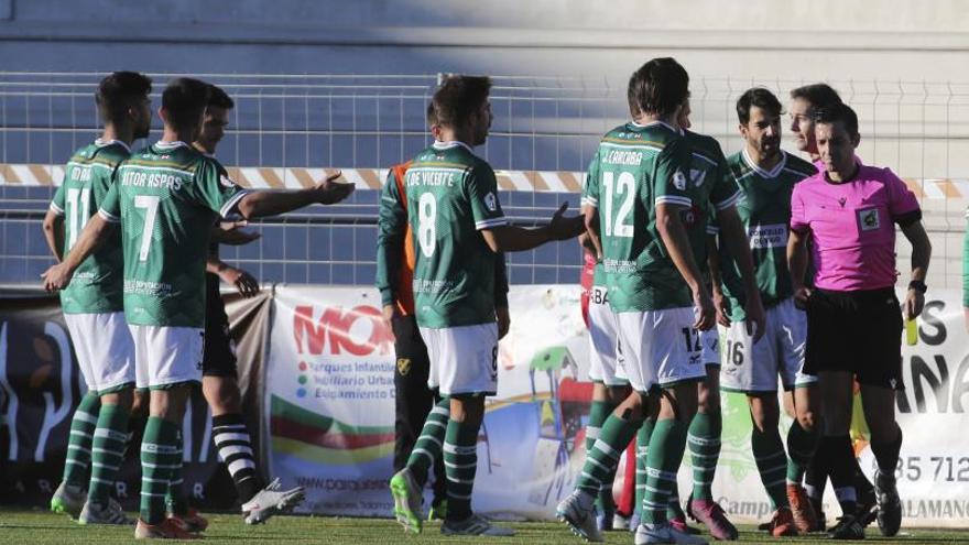 Los jugadores del Coruxo protestan al árbitro la concesión del 1-0 pese a que su asistente había levantado la bandera. |  // LA GACETA DE SALAMANCA