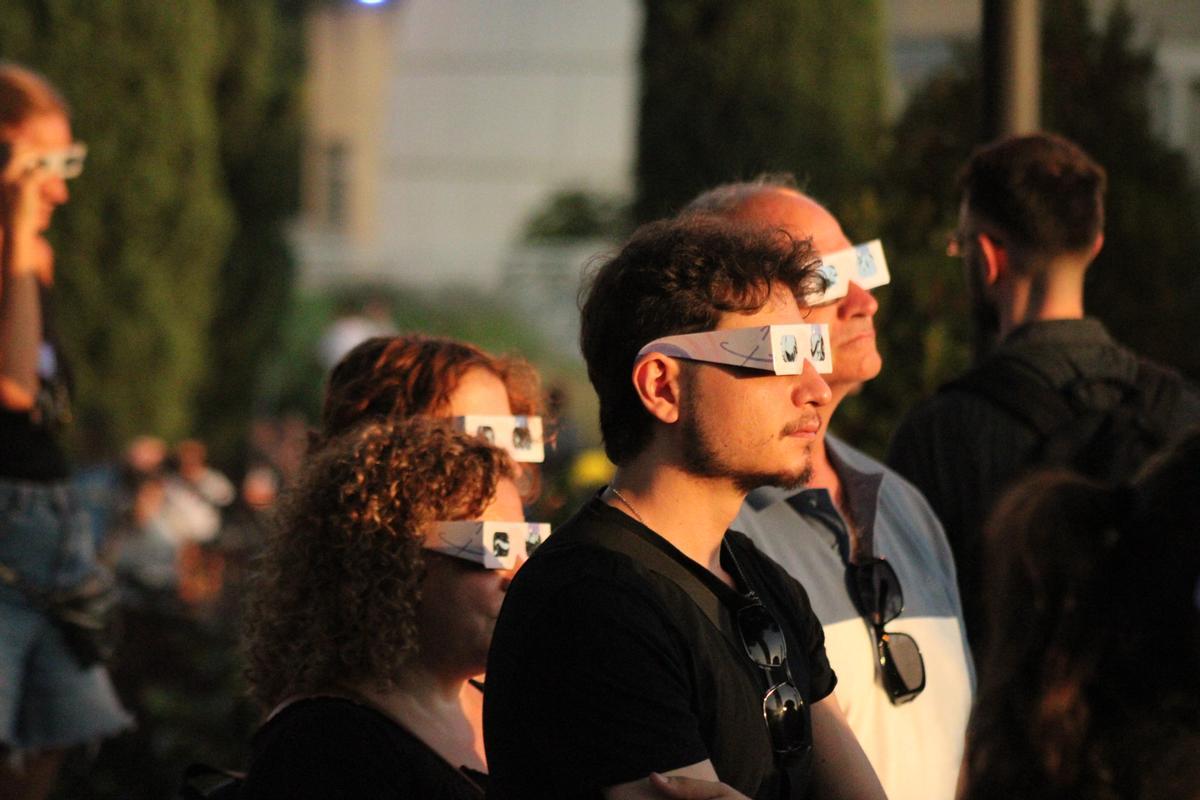 Una familia observa el eclipse solar momentos antes de llegar a su máxima ocultación