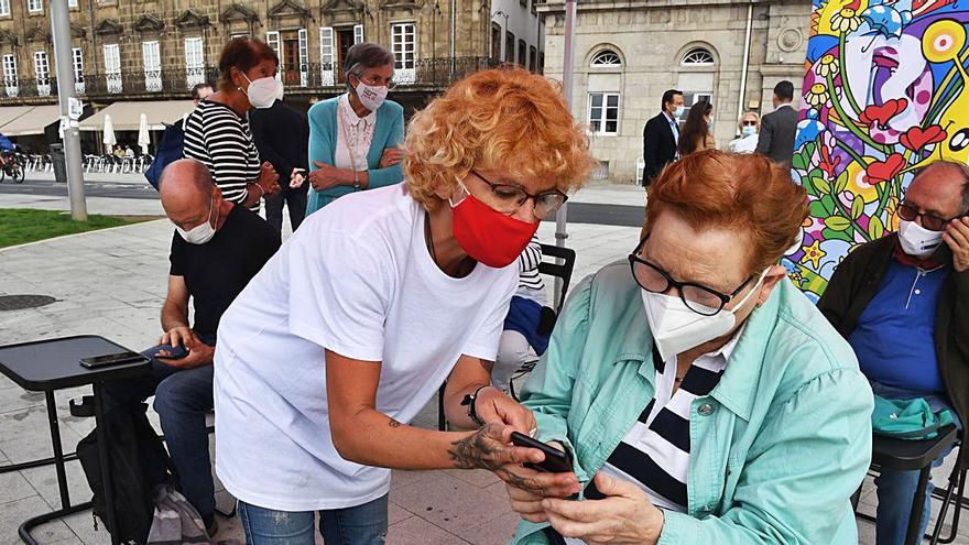 Una usuaria del ‘Enredando Tour’ es ayudada por una voluntaria del programa, ayer, en A Coruña.  | // C. PARDELLAS