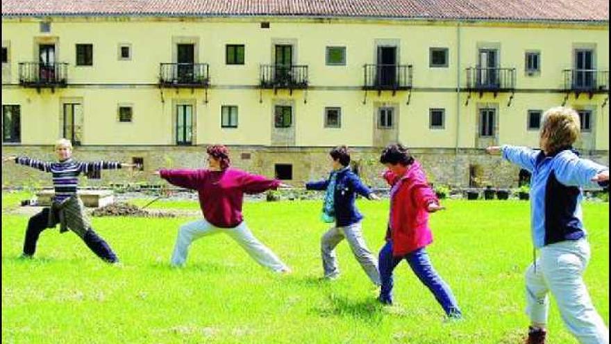 Practicantes de yoga, en una clase al aire libre, en Valdediós.