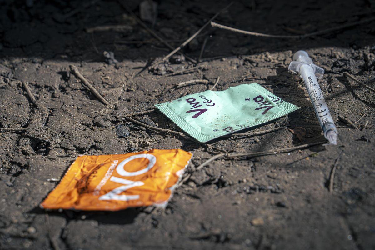 Condones y jeringuillas en el suelo.