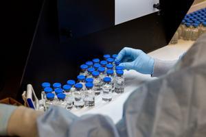 A lab technician inspects filled vials of investigational coronavirus disease (COVID-19) treatment drug remdesivir at a Gilead Sciences facility in La Verne, California, U.S. March 11, 2020. Picture taken March 11, 2020. Gilead Sciences Inc/Handout via REUTERS. NO RESALES. NO ARCHIVES. THIS IMAGE HAS BEEN SUPPLIED BY A THIRD PARTY.