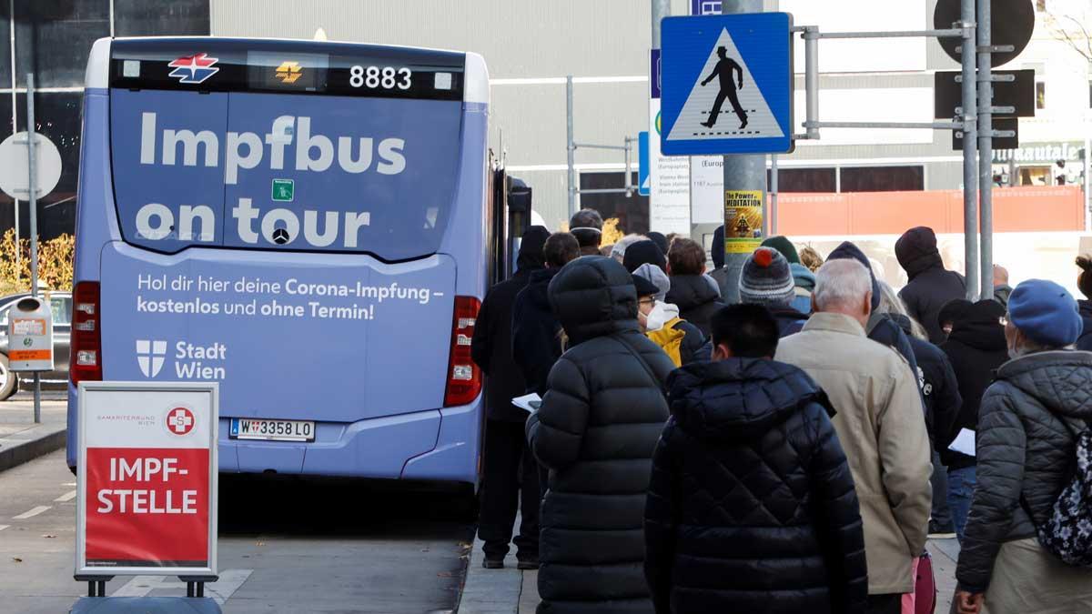 Un grupo de gente hace cola en un bus de vacunación contra el coronavirus, en Viena