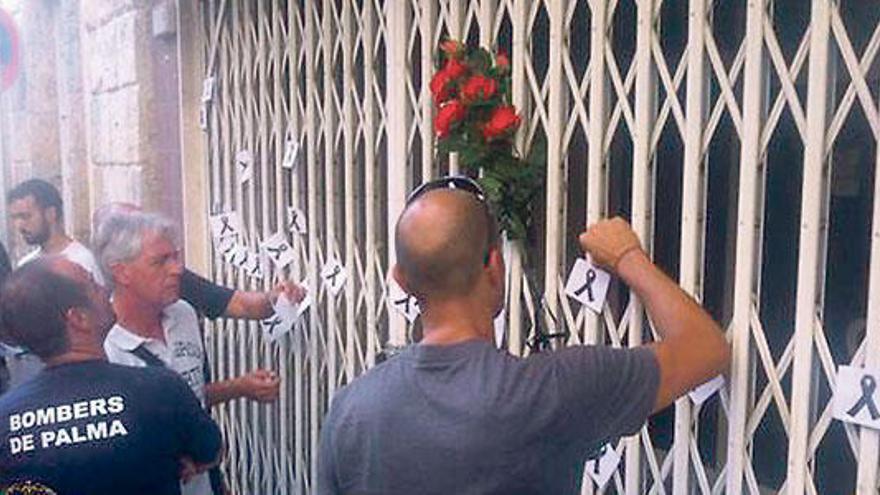 Bomberos de Palma cuelgan flores y crespones en el bar donde falleció su compañero.