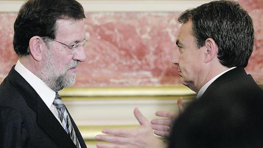 Un momento de la conversación entre Mariano Rajoy y José Luis Rodríguez Zapatero, ayer, en el Congreso.
