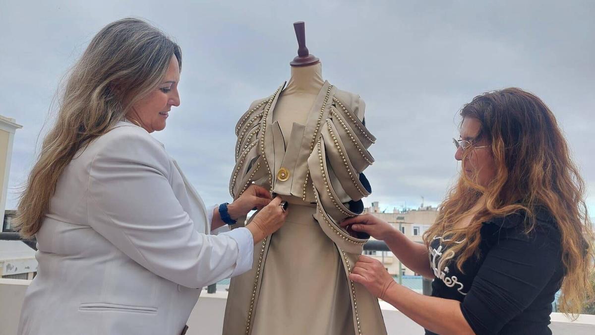 Dos integrantes de Up'telier trabajan en la confección de un traje