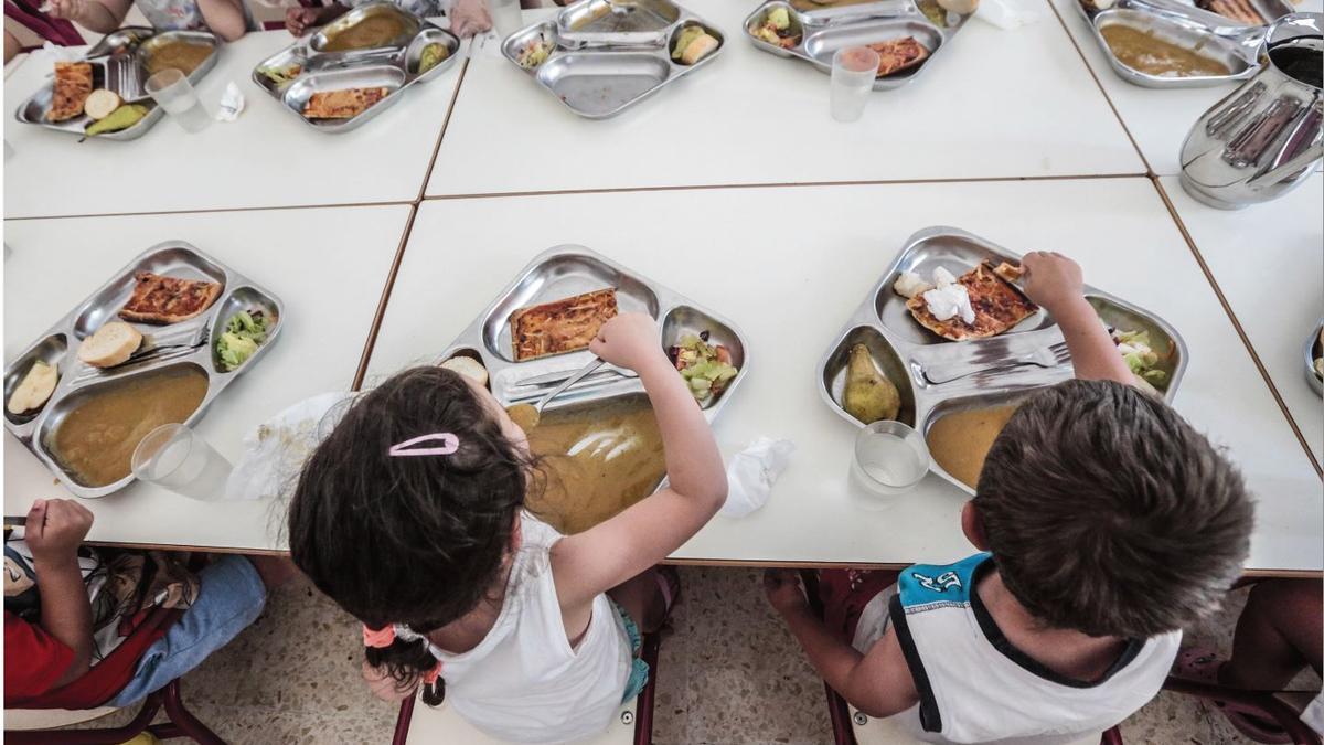 Alumnes amb els seus menus, en un menjador escolar.
