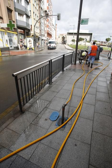 Trabajos de limpieza en la calle Llano Ponte de Avilés tras las inundaciones