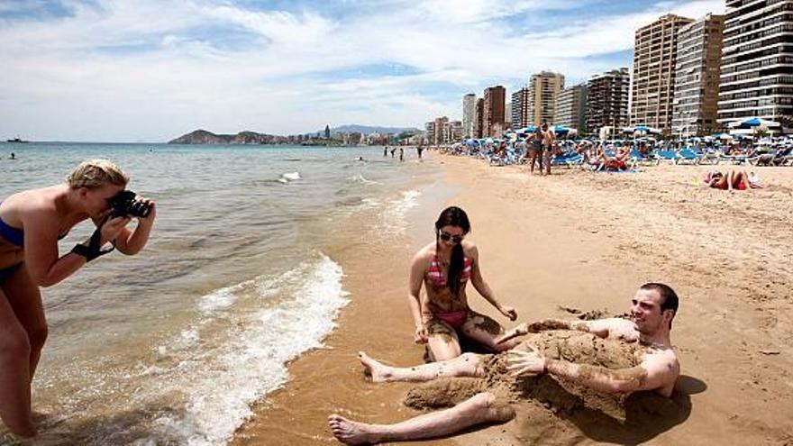 Varios usuarios de la playa de Levante de Benidorm, disfrutando ayer de la primera línea.