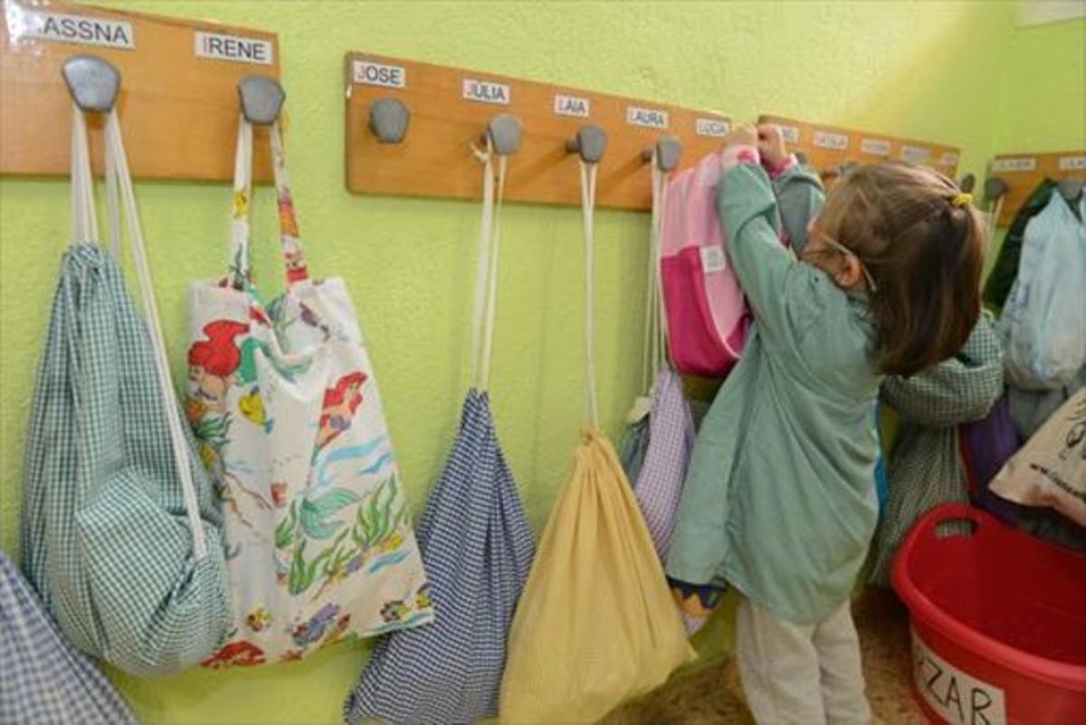 Una niña cuelga su mochila en el CEIP Antoni Gaudí de Cornellà. Una niña cuelga su mochila en el CEIP Antoni Gaudí de Cornellà.