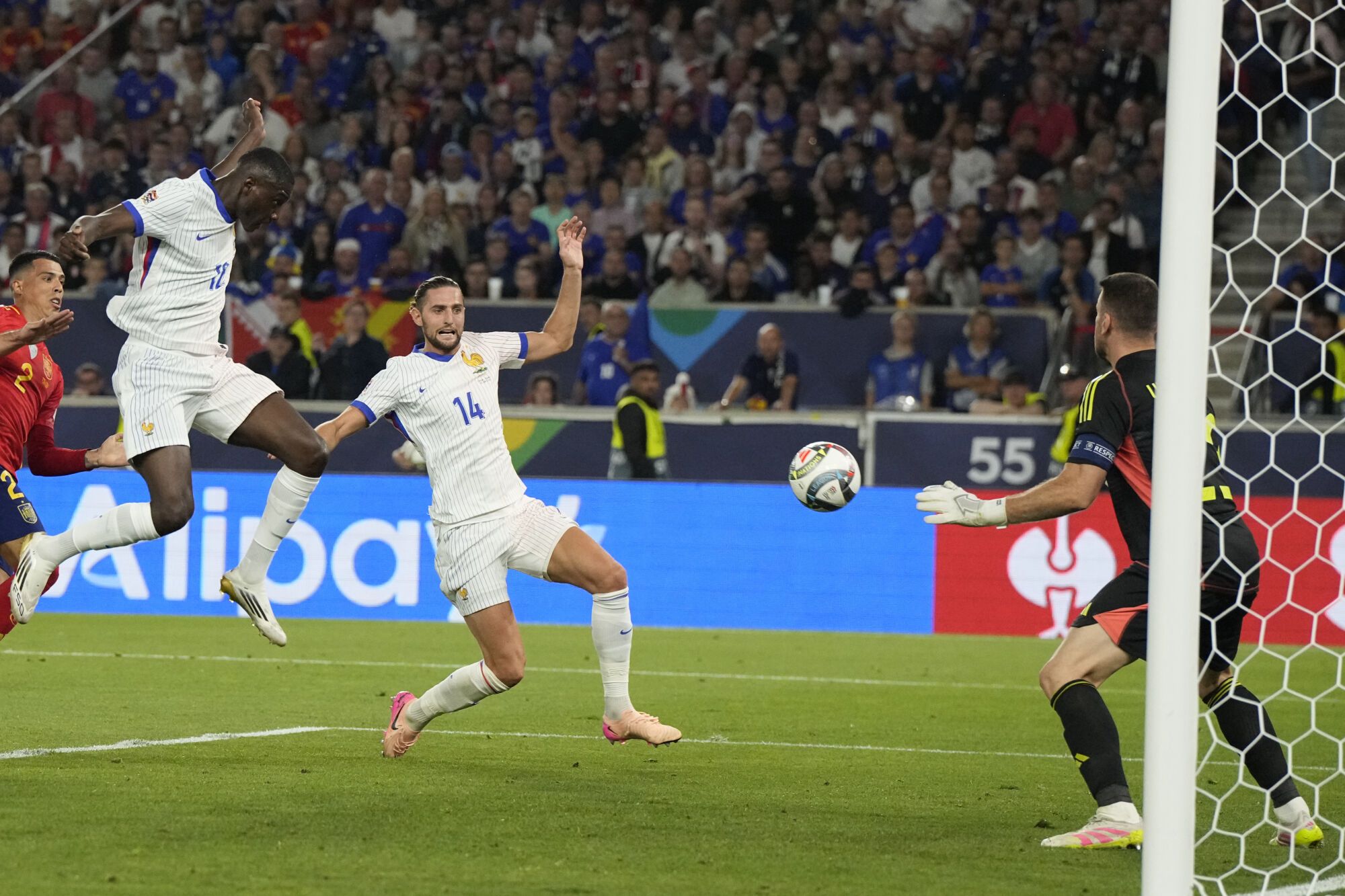 France's Randal Kolo Muani, left, scores his side's 4th goal against Spain during the Nations League semifinal soccer match between Spain and France at the MHPArena, in Stuttgart, Germany, Thursday, June 5, 2025. (AP Photo/Martin Meissner)