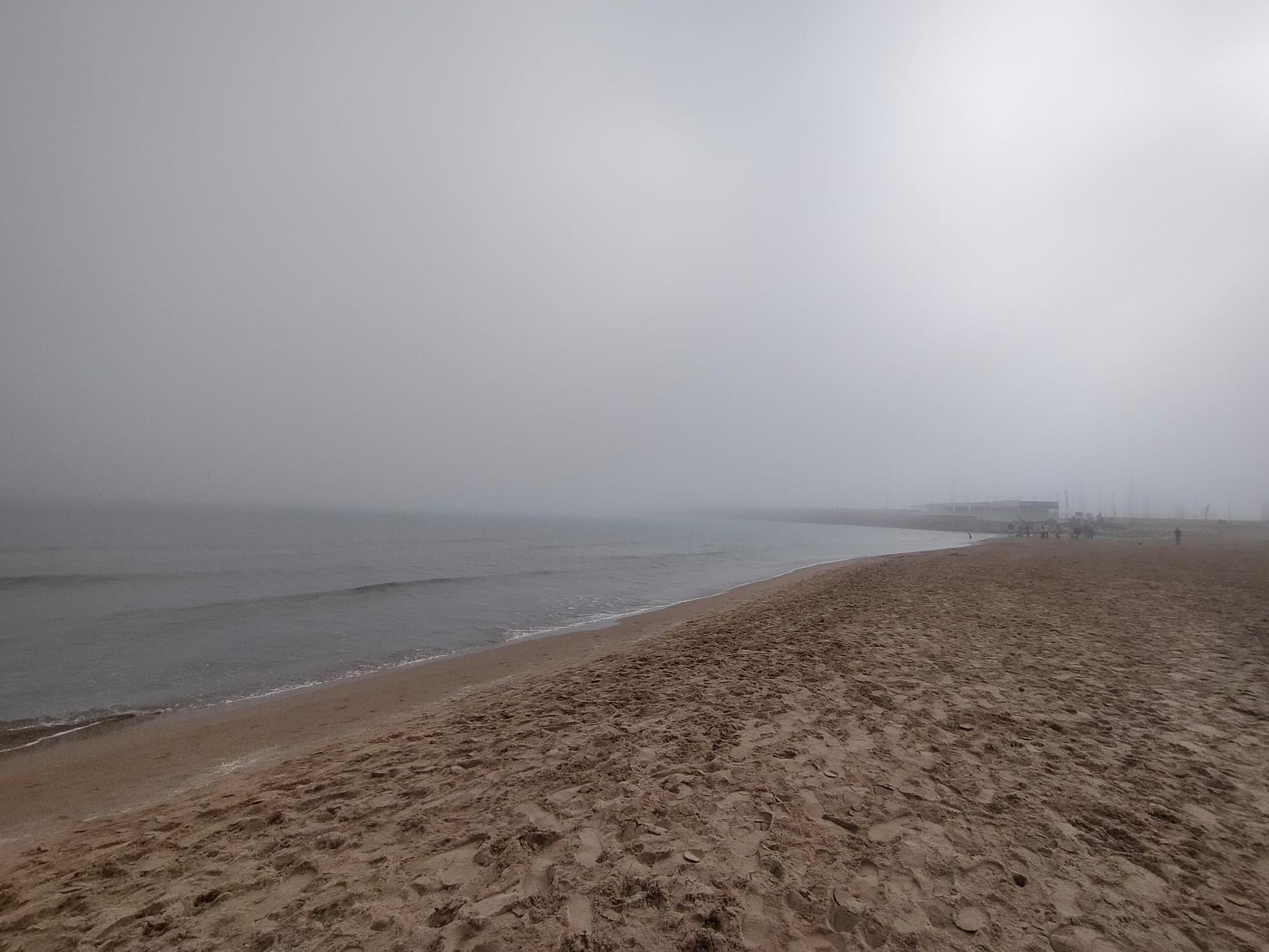 La playa de Gandia desaparece entre la niebla