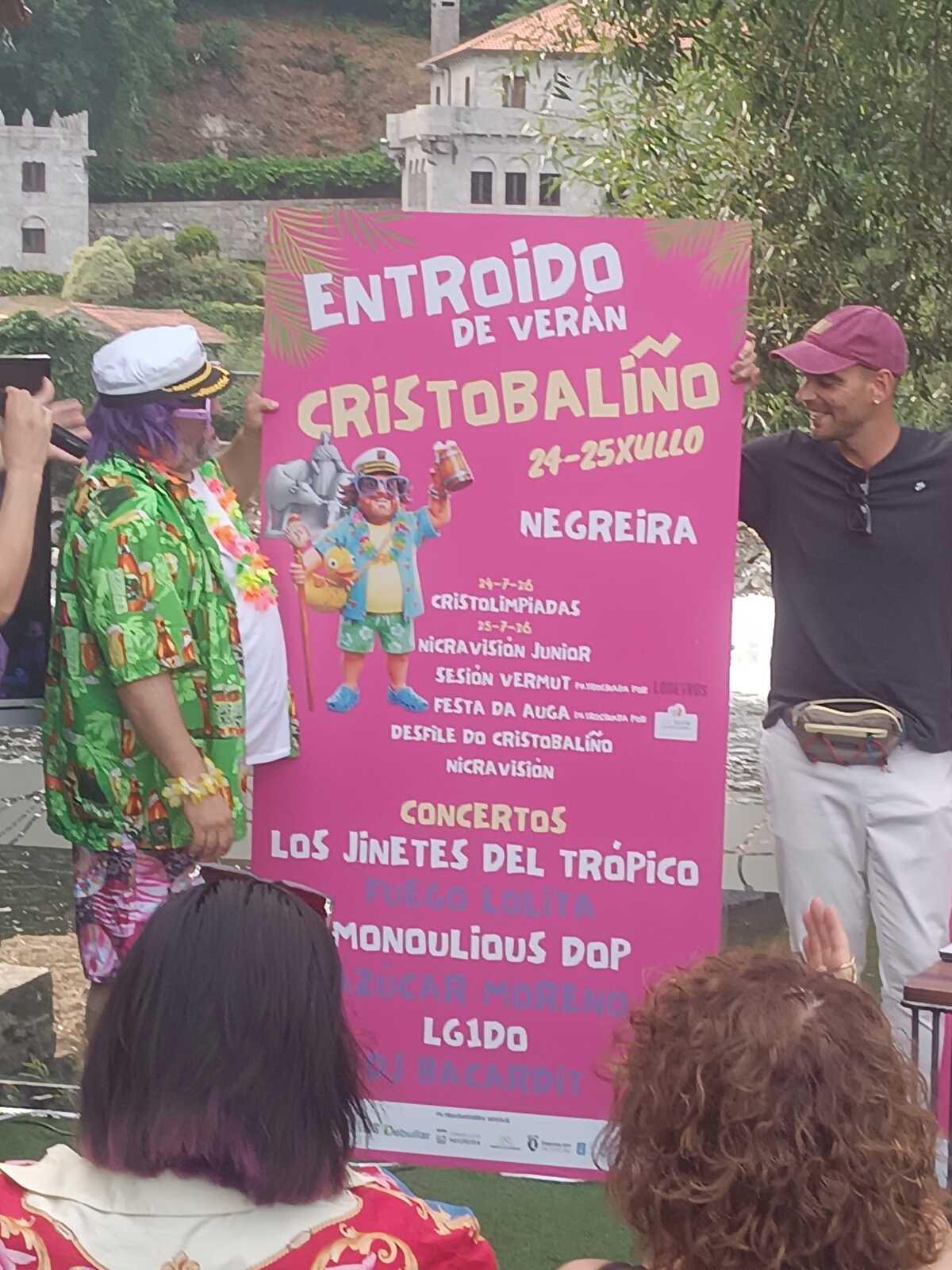 Cristobaliño, izquierda, con el cartel del Entroido de Verán de Negreira
