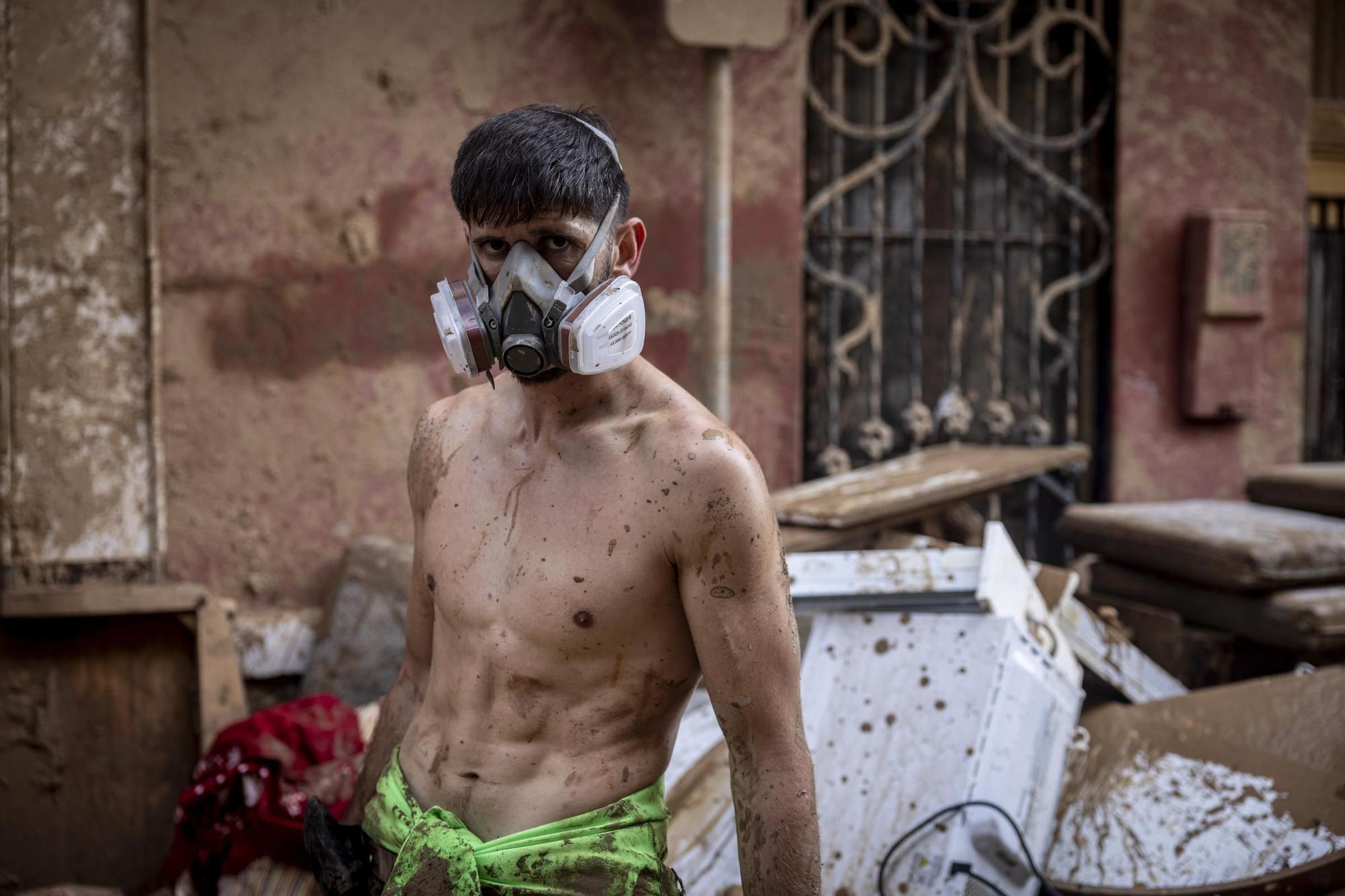 Un joven vecino de Massanassa, mientras extraía mobiliario de su vivienda, inundada por el lodo.