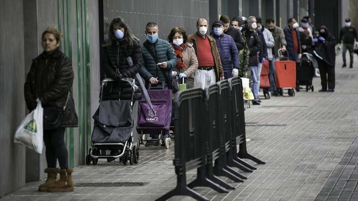 Miquel Buch dice que no es una obligación llevar mascarilla por la calle, pero sí una recomendación. En la foto, cola en un supermercado de L’Hospitalet.