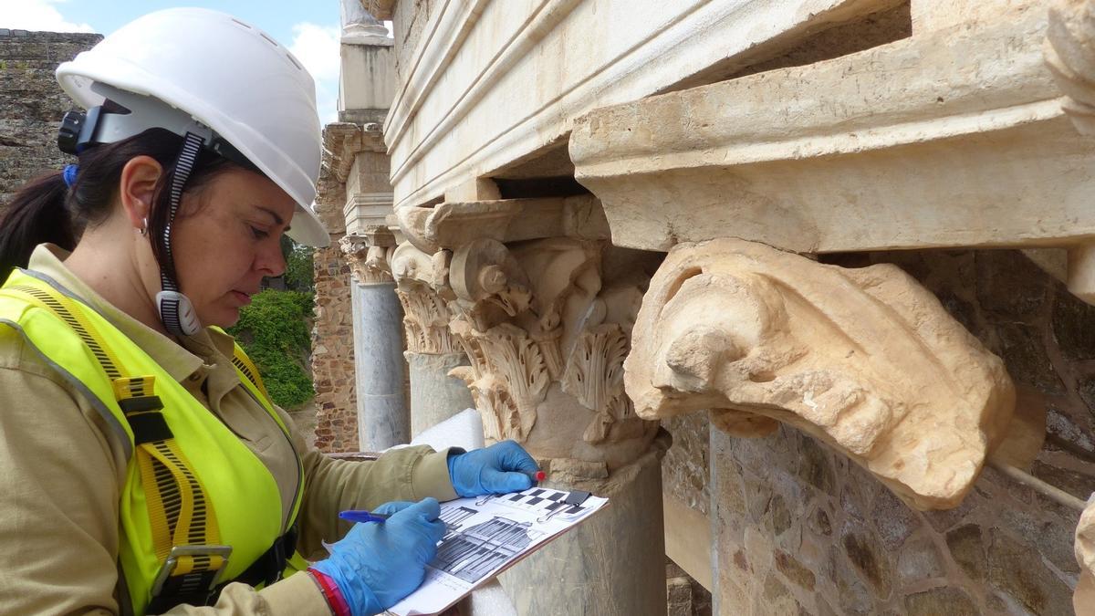 Una trabajadora del Consorcio de la Ciudad Monumental de Mérida realizando trabajos en el frente escénico del Teatro Romano.