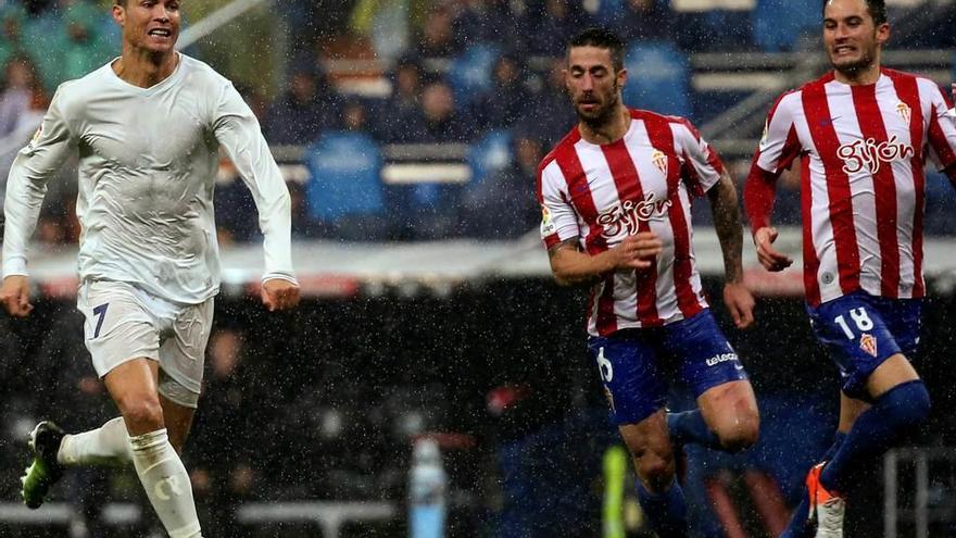 Cristiano conduce el balón perseguido por Lillo e Isma López.