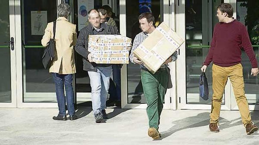 Agentes de la Policía Judicial salen del Concello con cajas de documentos. // Casteleiro