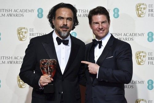 Best director Alejandro Inarritu holds his award as he stands with presenter Tom Cruise at the British Academy of Film and Television Arts (BAFTA) Awards at the Royal Opera House in London