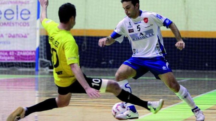 El jugador del Arcebansa Zamora Pipe hace un recorte a Márquez, futbolista del Maristas Valencia.