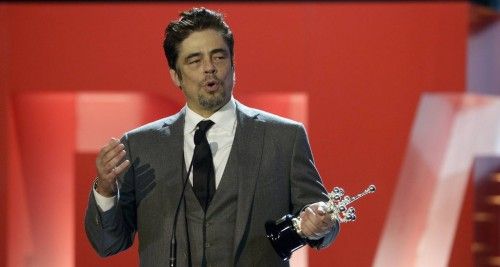 Puerto Rican actor Del Toro speaks while holding his trophy after receiving the Donostia Award for career achievement at the 62nd San Sebastian Film Festival
