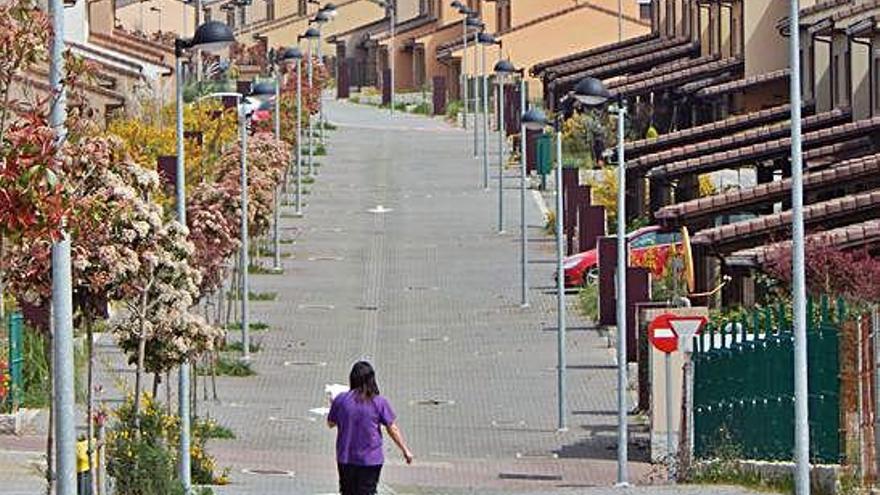 Una mujer camina por una de las calles de la macrourbanización Costa Miño Golf.