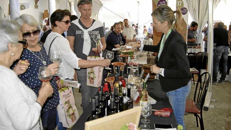 Una de las bodegueras escanciando vino a unos turistas.