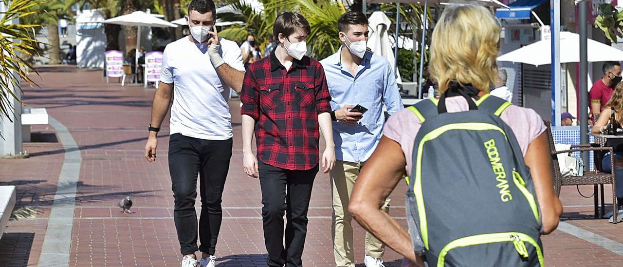 Tres jóvenes caminan por el paseo de Las Canteras, en la capital grancanaria. | | ANDRÉS CRUZ