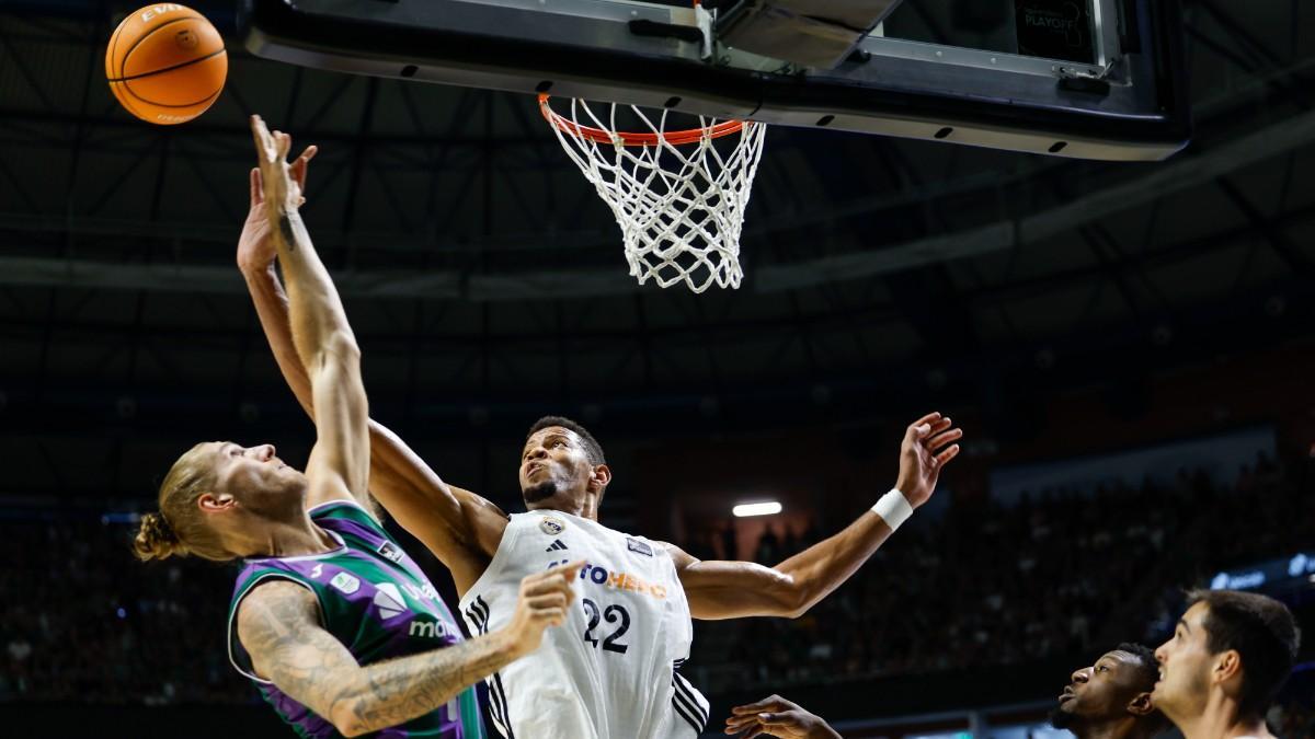 Unicaja's German eaves Dylan Ostkowski (i) before the Pivot of Cabo Verde of Real Madrid Edy Tavares (c) this Sunday, during the third semifinal match of the Endesa Basketball League, between Unicaja and Real Madrid, at the José María Martín Carpena de Malaga Sports Palace (Andalusia)