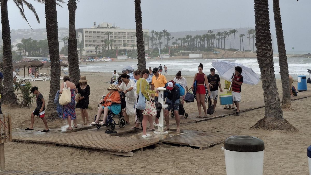 Los bañistas hacen cola para quitarse la arena de los pies y salir de la playa