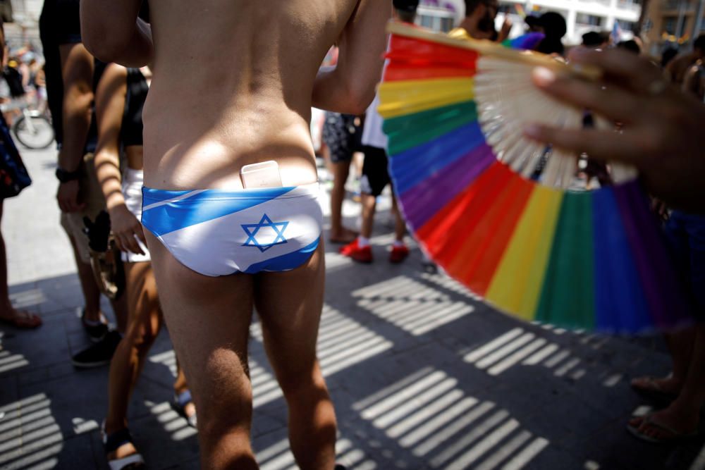 Revellers take part in a gay pride parade in Tel ...