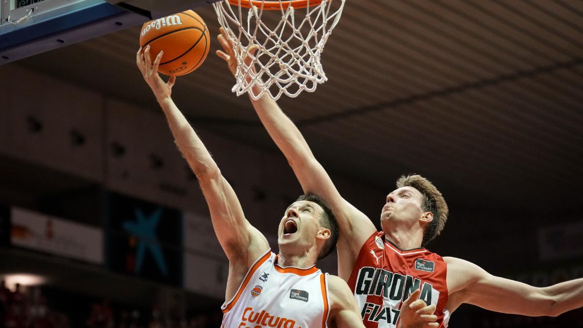 El alero del Valencia Basket Xabi López-Arostegui entra a canasta defendido por Mindaugas Susinskas, del Básquet Girona